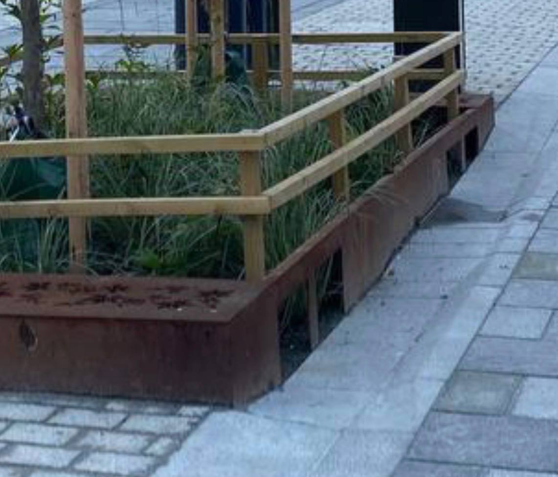 Detail otvorů ve stěně květníku, kterými voda vtéká k rostlinám